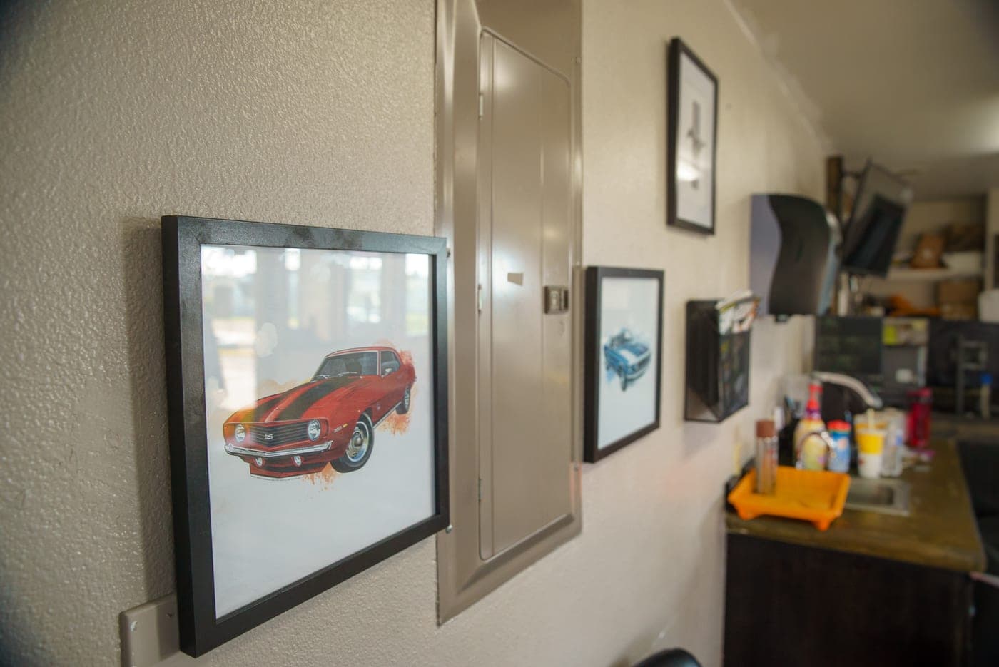 Classic car artwork decorating the Grays Harbor lobby