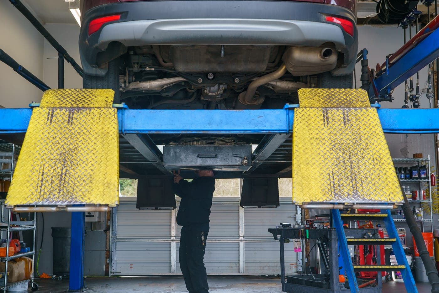 A vehicle up on the lift in the Warrenton service bay